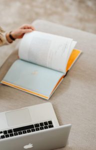 Overhead view of a student studying with a laptop and books indoors.